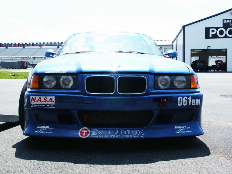 Blue BMW E36 M3 front view with racing decals and "061BM" number