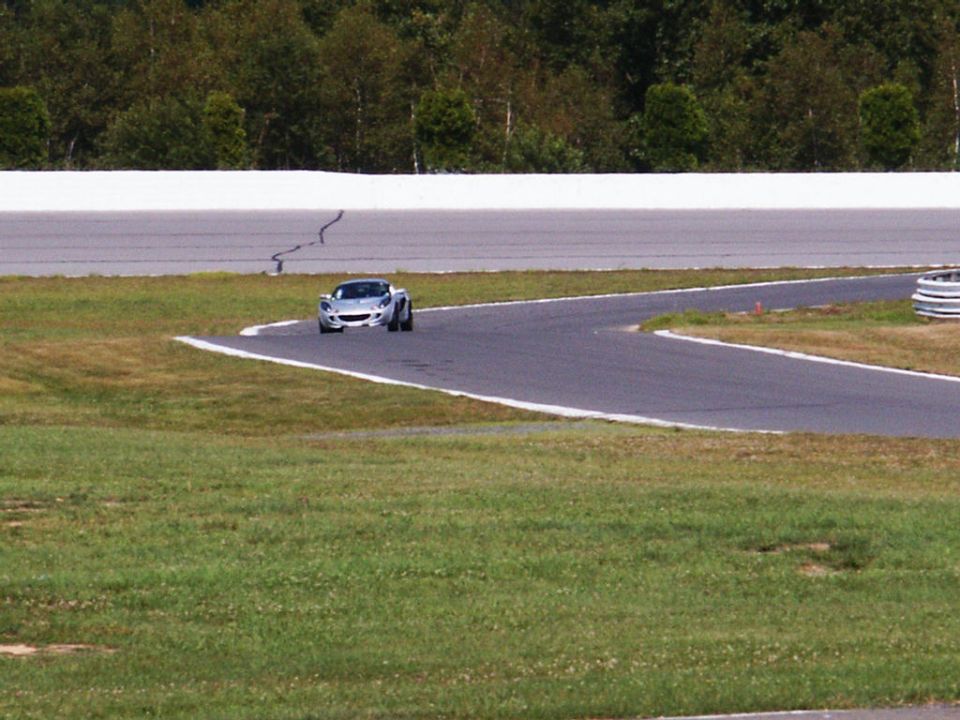 Silver sports car on a race track corner