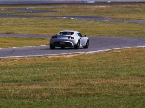 2001 Mercury Grand Marquis - A silver sports car navigates a turn on a race track.