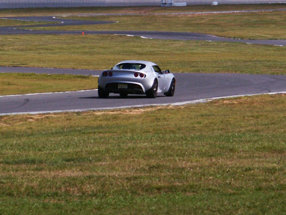 Silver sports car on race track, rear view