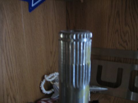 1986 Ford F-150 - A close-up shows a splined shaft, possibly a vehicle part, against a wood-paneled background.