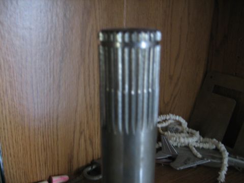 1986 Ford F-150 - A close-up view of a metal splined shaft is visible against a wood-paneled wall.