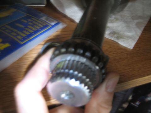 1986 Ford F-150 - A close-up view of a splined metal component, possibly from a vehicle's drivetrain, is held for inspection.