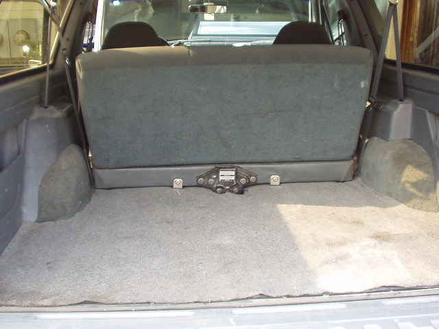 Gray folding rear seat and cargo area of an SUV or wagon