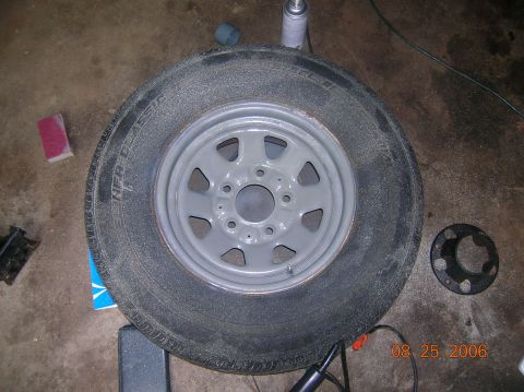 1996 Ford Bronco - A tire and rim are shown on a concrete floor, with a sand block and spray can nearby. The date stamp reads 08.25.2006.