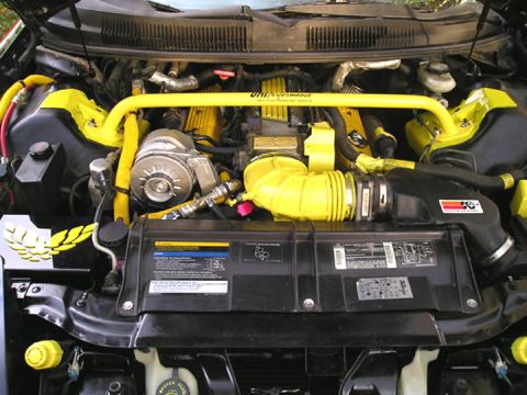 1984 Pontiac Fiero - Engine bay features yellow accents on intake, strut bar, and valve covers, with a K&N filter.
