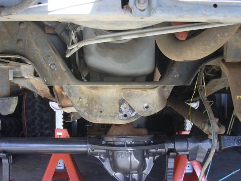 1991 Ford Bronco - Close-up of vehicle undercarriage, focusing on the rear differential and suspension parts.
