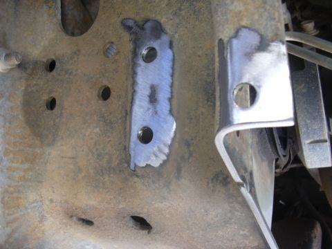 1991 Ford Bronco - A newly welded bracket is attached to the vehicle's frame, showing signs of rust and modification.