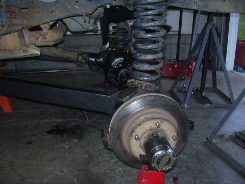 1991 Ford Bronco - Close-up view of a vehicle's undercarriage, showing suspension and brake components.