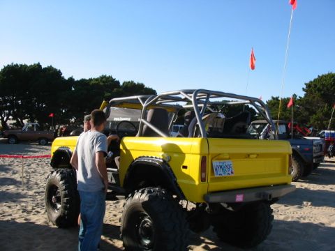1995 Ford Bronco - Modified 1995 Ford Bronco on the sand with a roll cage and oversized tires.