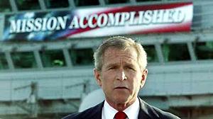 1969 Ford Mustang - President George W. Bush stands before a "MISSION ACCOMPLISHED" banner, a significant moment in recent history.