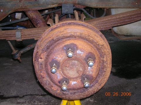 1996 Ford Bronco - Rear brake drum and suspension components showing significant rust, photographed on August 26, 2006.