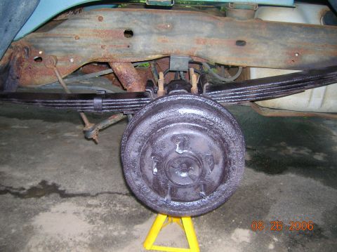 1996 Ford Bronco - Close-up of a vehicle's rear axle and suspension system, showing the drum brake assembly.