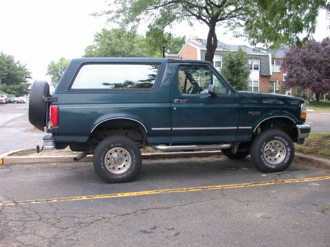 1995 Ford Bronco - Side profile of a 1995 Ford Bronco, showing its classic body style and spare tire mount.