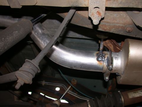 1995 Ford Bronco - Custom exhaust pipe welded to muffler, showing suspension components.