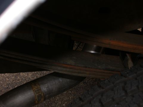 1995 Ford Bronco - The underside of a vehicle shows the exhaust system and suspension components.