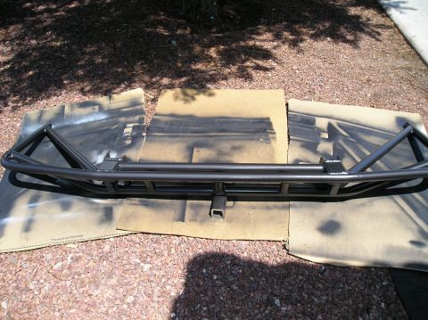 1993 Ford Bronco - A custom-fabricated rear prerunner bumper is shown laid out on cardboard, likely before installation.