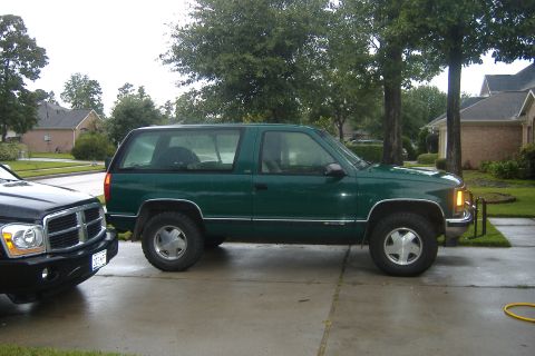 1994 Chevrolet Blazer - A green 1994 Chevrolet Blazer is parked in a driveway next to another vehicle.