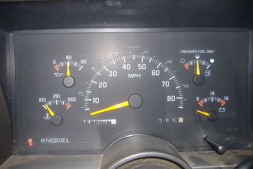Vehicle dashboard with speedometer, fuel gauge, oil pressure gauge, temperature gauge, and odometer showing 141257