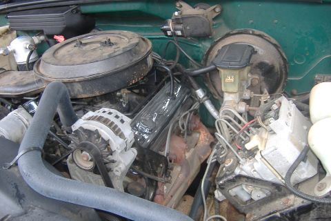 1994 Chevrolet Blazer - Close-up view of the engine compartment, showing various mechanical components and hoses.