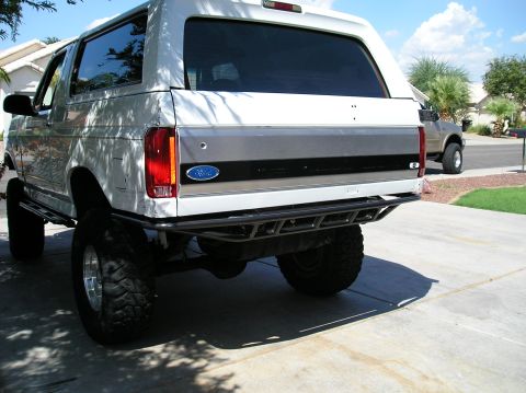 1993 Ford Bronco - This lifted 1993 Ford Bronco features a custom rear bumper and is parked in a driveway.