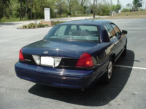 2000 Ford Crown Victoria - Rear 3/4 view of a dark blue 2000 Ford Crown Victoria parked in a lot.