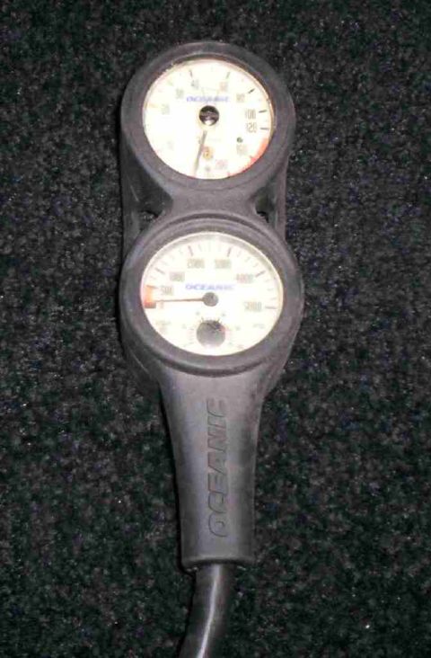 1986 Ford Bronco - Pair of Oceanic diving gauges showing air pressure and depth readings.