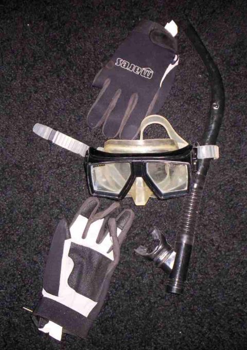 1986 Ford Bronco - A Mares mask, snorkel, and gloves are laid out on a dark, textured surface.