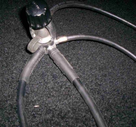 1986 Ford Bronco - A close-up view of a gas regulator assembly with multiple hoses attached.