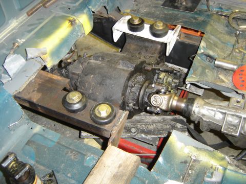1997 Ford Ranger - Transmission and driveshaft components are being installed into a vehicle's chassis.