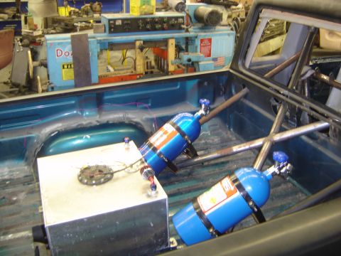 1997 Ford Ranger - Customized pickup truck bed features two blue nitrous oxide tanks and a large fuel cell, with roll cage visible.