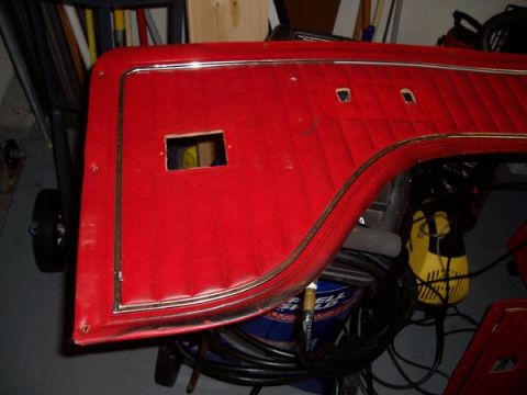 1978 Ford Bronco - A red interior door panel with chrome trim and diamond stitching is shown, likely for a classic vehicle.