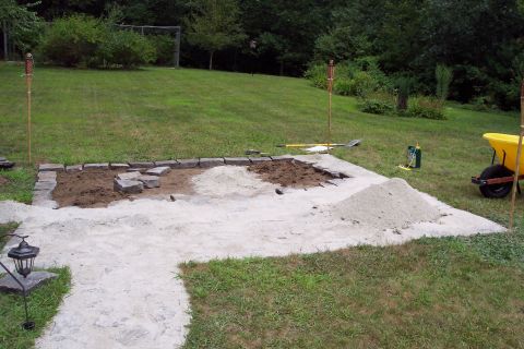 2001 Ford Crown Victoria - A patio construction site is shown with materials laid out on the grass.