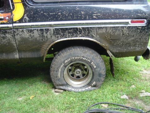 1979 Ford F-250 - This 1979 Ford F-250 shows significant mud coverage and a flat rear tire.