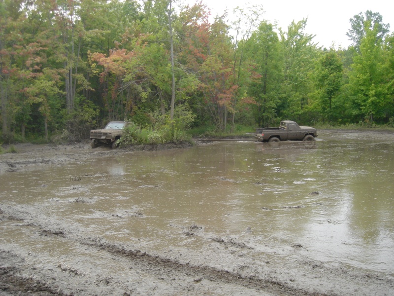 1979 Ford F-250 stuck in mud with another truck nearby