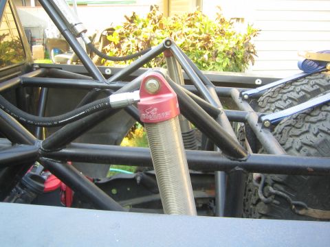 1968 Ford Mustang - Custom suspension and roll cage components on an off-road vehicle, with a spare tire secured.