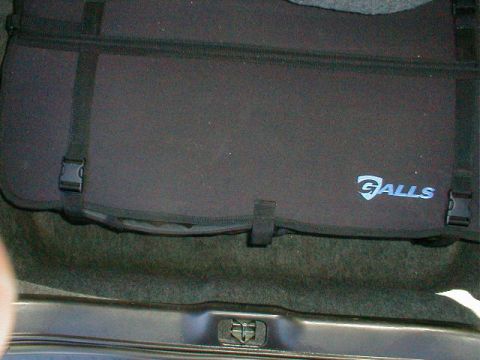 2002 Ford Crown Victoria - A black fabric trunk organizer with the Galls logo is secured with straps inside a vehicle's trunk.