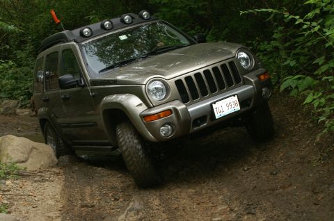 2006 Jeep Liberty - A 2006 Jeep Liberty navigates a rocky, wooded trail.