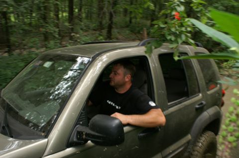 2006 Jeep Liberty - Driver navigates a Jeep Liberty through a dense forest trail.