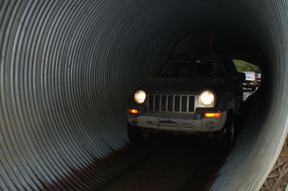 Front view of a 2006 Jeep Liberty driving through a tunnel, with another vehicle visible in the distance