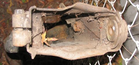 1984 Ford Bronco - Close-up of a corroded suspension part, likely from an older vehicle.