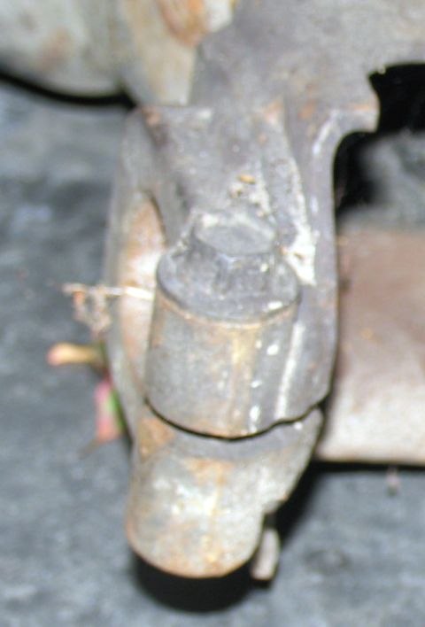 1984 Ford Bronco - A close-up view of a rusty suspension part, likely from an older vehicle.