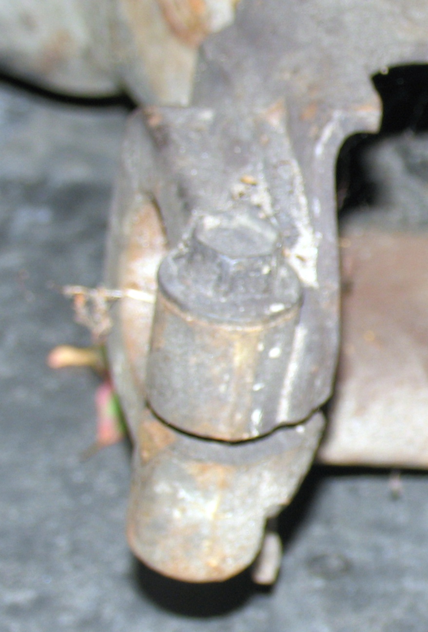 Close-up of a rusty suspension component with a bolt