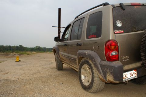 2006 Jeep Liberty - A Jeep Liberty is seen from the rear on a dirt road with trees in the background.