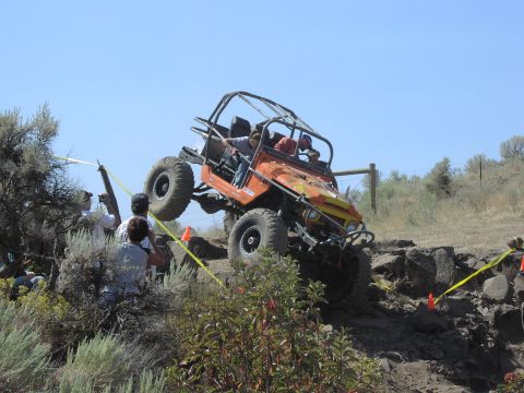 1979 Ford Bronco - This modified buggy is navigating a challenging off-road course with spectators observing the action.