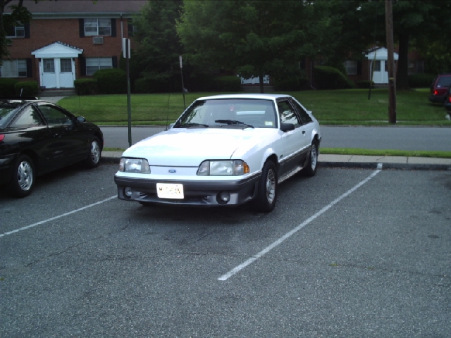 White 1989 Ford Mustang coupe parked in a lot, 3q-front view