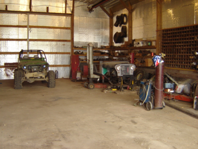 Green off-road vehicle parked inside a garage