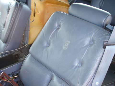 1993 Ford Taurus - Interior view of blue leather car seats, showing tufted design and an embroidered emblem on the seatback.