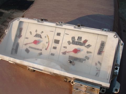 1993 Ford Taurus - Instrument cluster with tachometer and speedometer, showing red-tipped needles and white gauges.