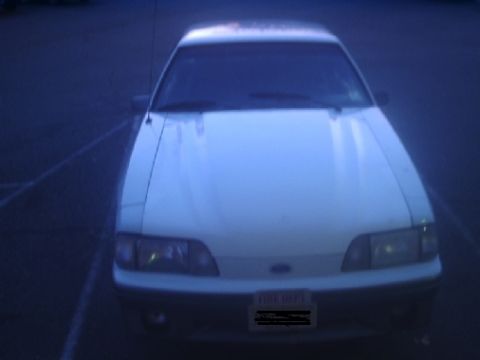 1989 Ford Mustang - Front view of a white 1989 Ford Mustang, identifiable by its body style and license plate.